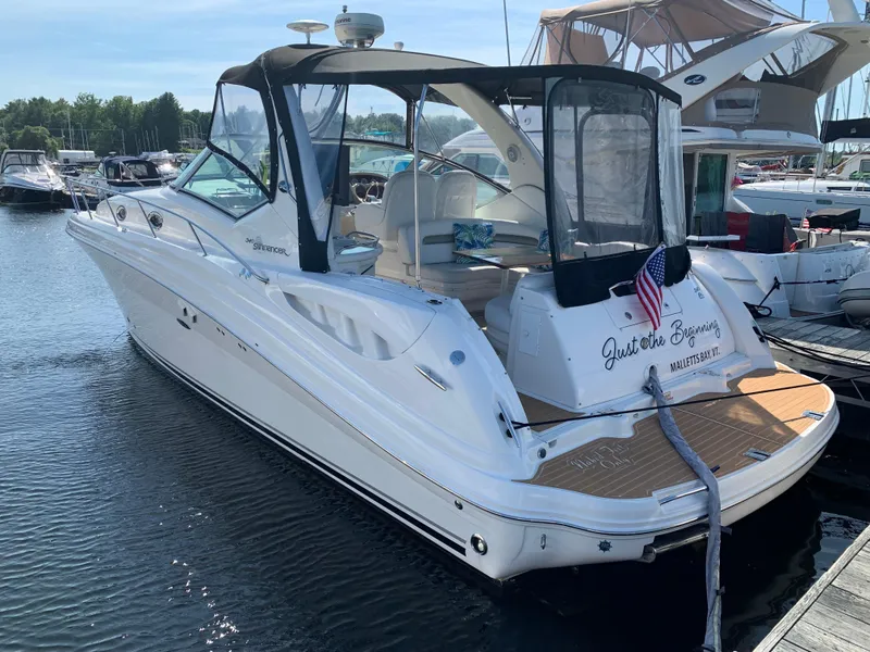 Slide: The Image of 2006 Sea Ray 340 Sundancer docked at marina, featuring sleek design and American flag. - 9