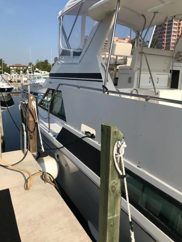 Slide: The Image of 1994 Hatteras 42 Cockpit Motor Yacht docked at marina. - 10