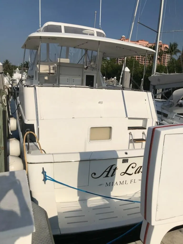 Slide: The Image of 1994 Hatteras 42 Cockpit Motor Yacht docked in Miami marina. - 11