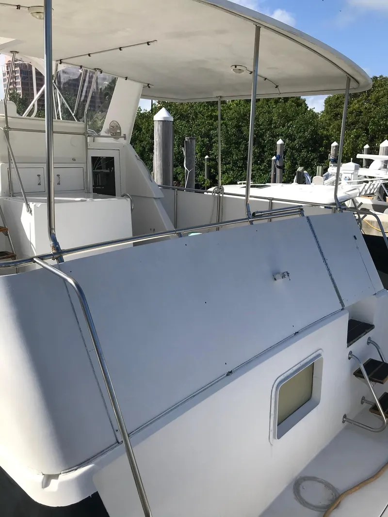 Slide: The Image of 1994 Hatteras 42 Cockpit Motor Yacht with spacious deck and canopy. - 12