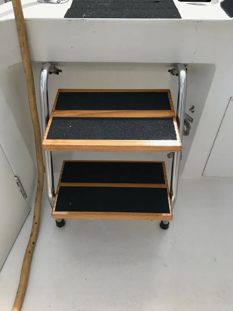 Slide: The Image of Sturdy wooden steps on a 1994 Hatteras 42 Cockpit Motor Yacht. - 16