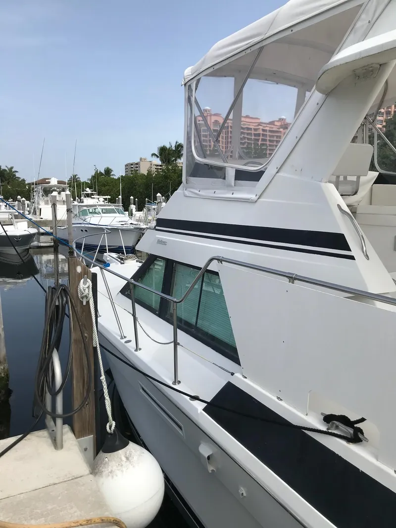 Slide: The Image of 1994 Hatteras 42 Cockpit Motor Yacht docked at marina, side view. - 2