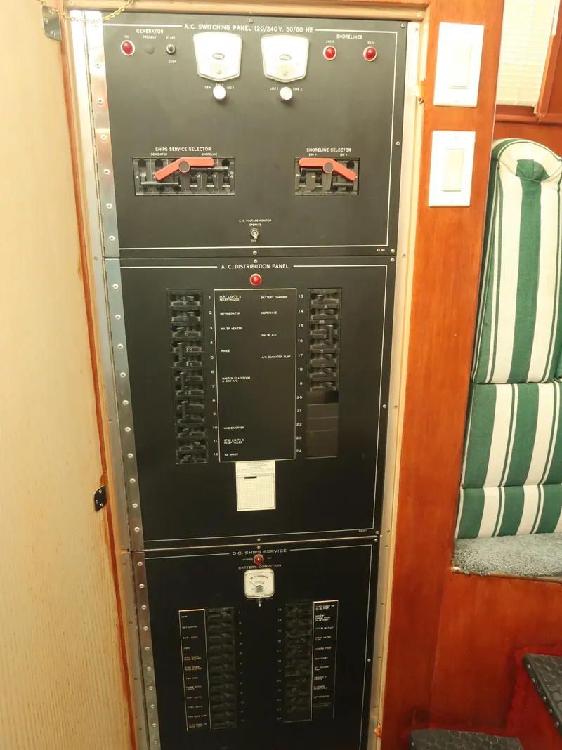 Slide: The Image of Electrical panel on a 1994 Hatteras 42 Cockpit Motor Yacht, featuring switches and circuit breakers. - 23