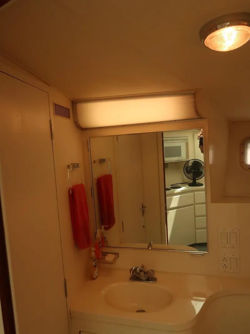 Slide: The Image of Bathroom interior of 1994 Hatteras 42 Cockpit Motor Yacht with sink and mirror. - 24