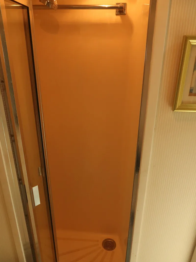 Slide: The Image of Shower area inside 1994 Hatteras 42 Cockpit Motor Yacht, featuring a compact design. - 25