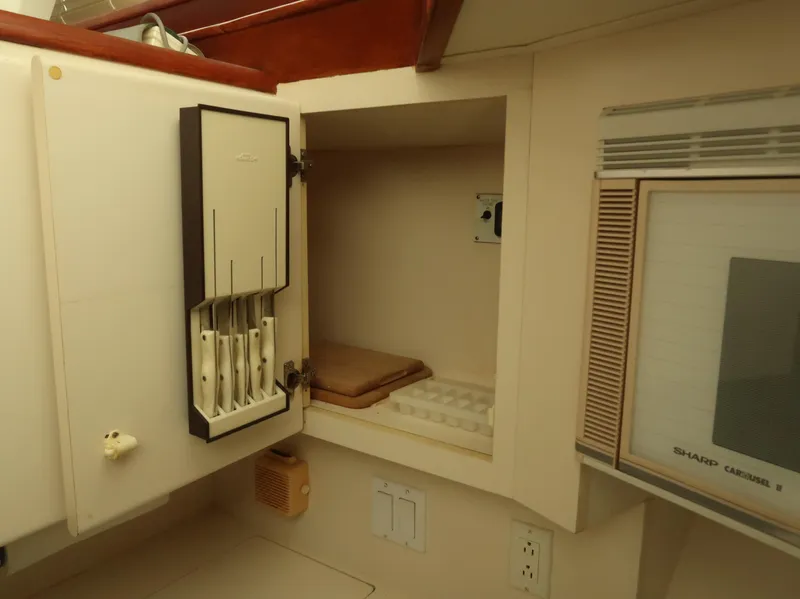 Slide: The Image of Interior of 1994 Hatteras 42 Cockpit Motor Yacht kitchen with knife holder and microwave. - 28