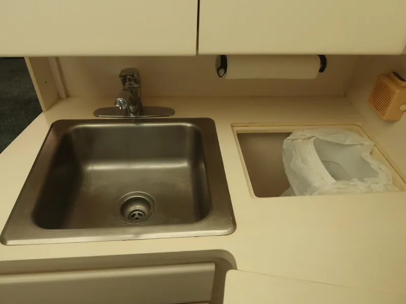 Slide: The Image of Kitchen sink area in a 1994 Hatteras 42 Cockpit Motor Yacht. - 29