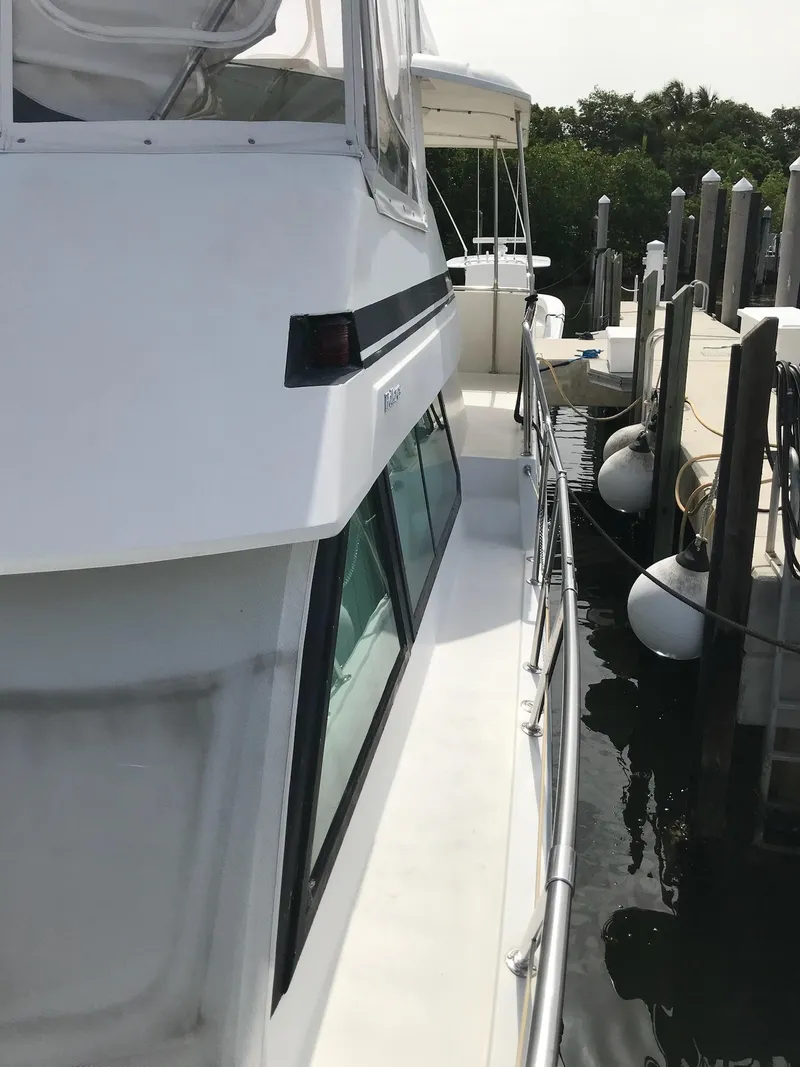 Slide: The Image of 1994 Hatteras 42 Cockpit Motor Yacht docked at marina. - 3