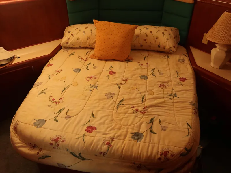 Slide: The Image of Cozy bedroom in 1994 Hatteras 42 Cockpit Motor Yacht with floral bedding. - 32