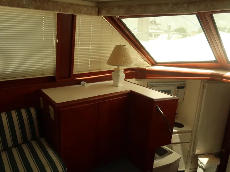 Slide: The Image of Interior of 1994 Hatteras 42 Cockpit Motor Yacht with lamp and striped seating. - 38