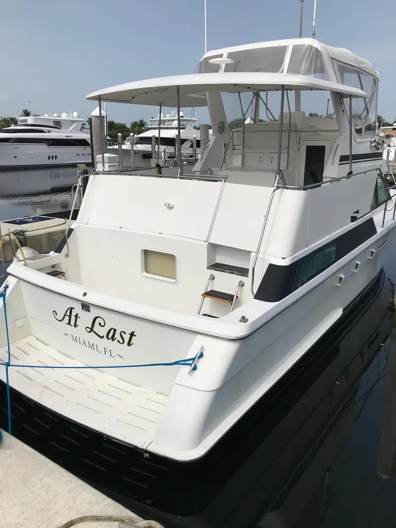 Slide: The Image of 1994 Hatteras 42 Cockpit Motor Yacht docked in Miami marina. - 5
