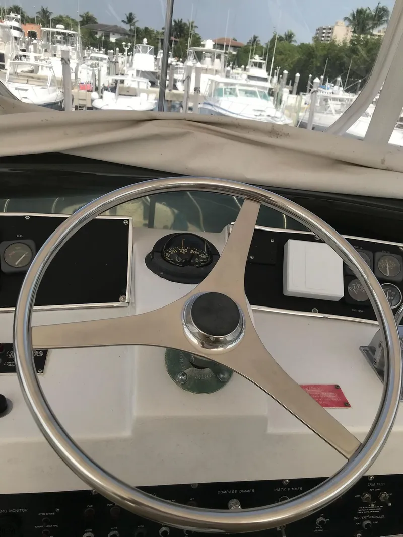 Slide: The Image of Steering wheel of a 1994 Hatteras 42 Cockpit Motor Yacht at a marina. - 6