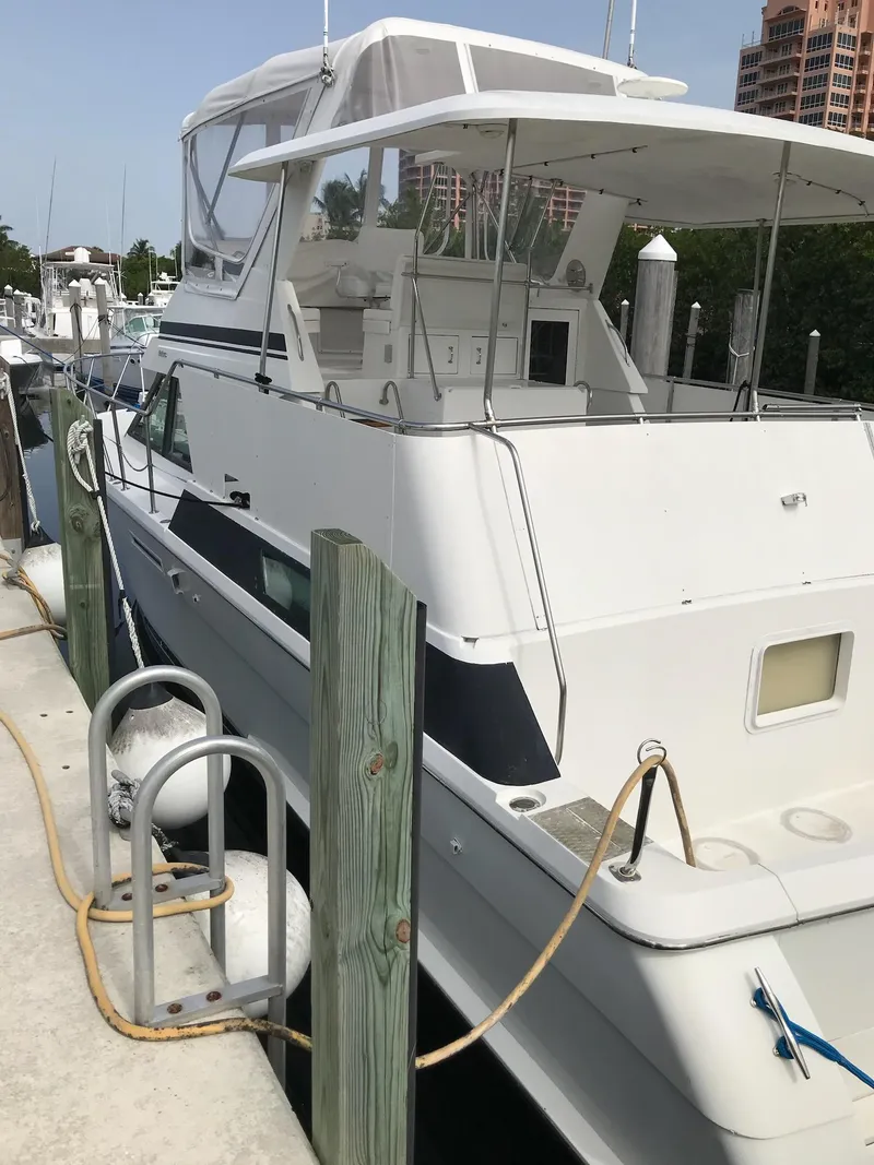 Slide: The Image of 1994 Hatteras 42 Cockpit Motor Yacht docked at marina, side view. - 8