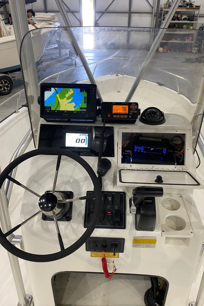 Slide: The Image of Control panel of a 2000 Triton 18 Sea Flight boat with navigation equipment. - 11