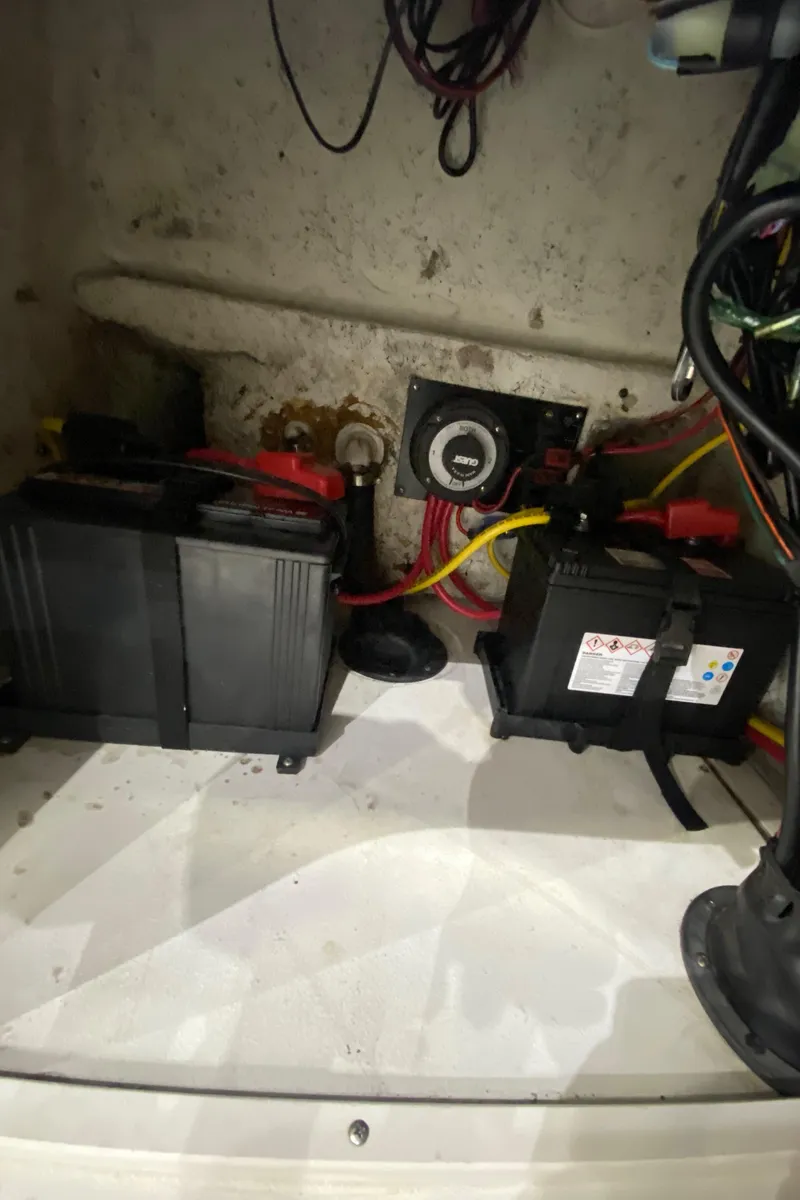 Slide: The Image of Battery compartment of a 2000 Triton 18 Sea Flight boat with wiring and components. - 16