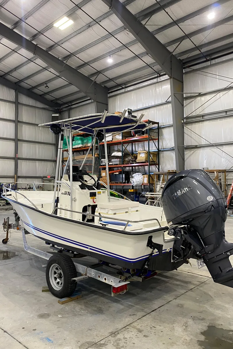 Slide: The Image of 2000 Triton 18 Sea Flight boat in warehouse, on trailer, with Yamaha outboard motor. - 3