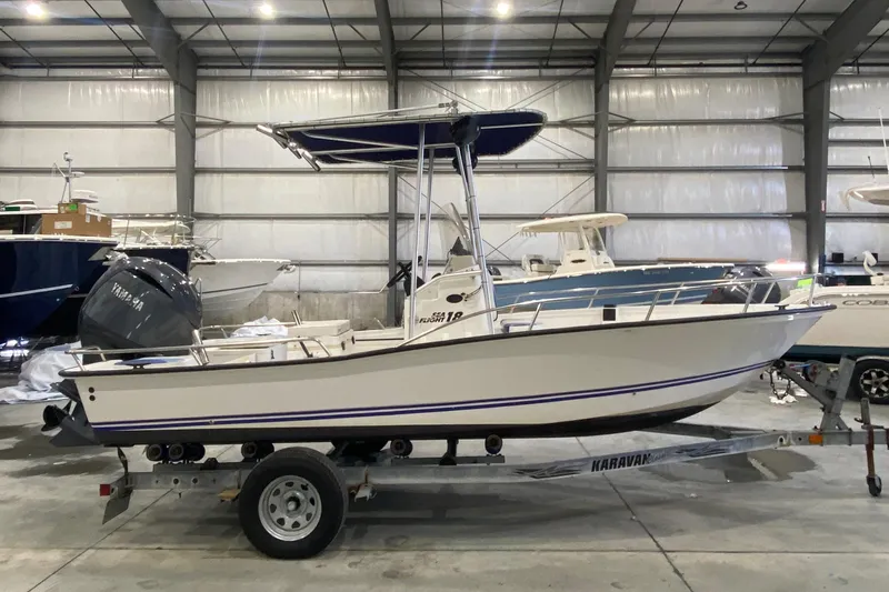 Slide: The Image of 2000 Triton 18 Sea Flight boat on trailer in indoor storage facility. - 4