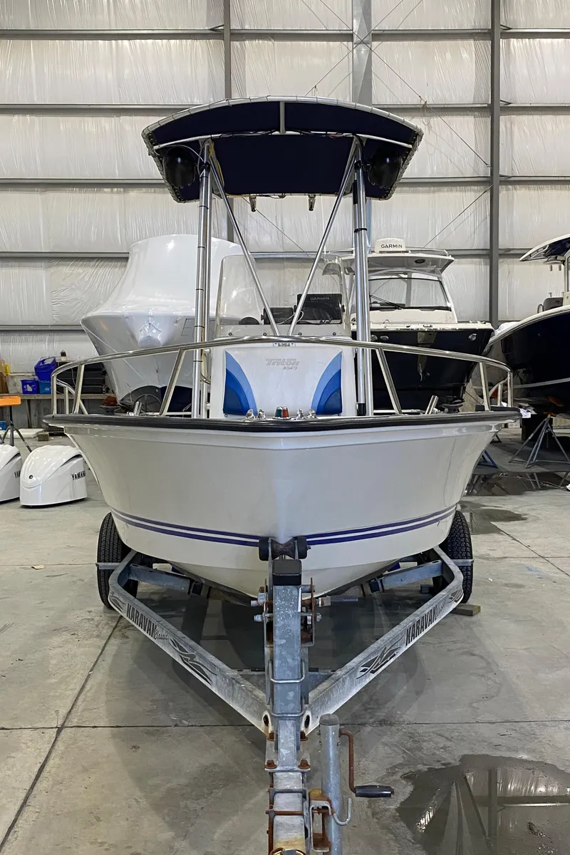 Slide: The Image of 2000 Triton 18 Sea Flight boat in storage, front view, on a trailer. - 5