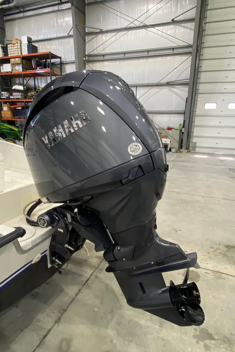 Slide: The Image of Outboard motor on a 2000 Triton 18 Sea Flight boat in a garage. - 6