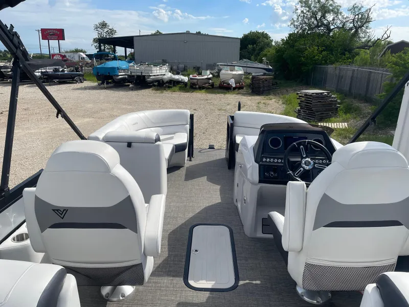 Slide: The Image of 2022 Misty Harbor Diamante Series boat interior with white seating and modern dashboard. - 13