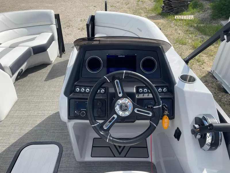 Slide: The Image of 2022 Misty Harbor Diamante Series boat dashboard with steering wheel and controls. - 15