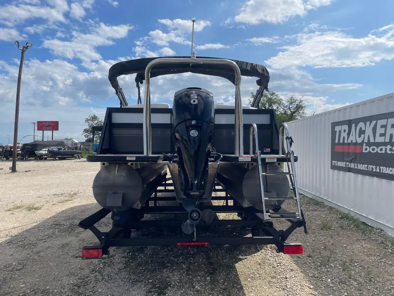 Slide: The Image of 2022 Misty Harbor Diamante Series pontoon boat with outboard motor, parked outdoors. - 2