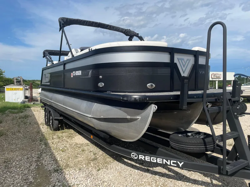 Slide: The Image of 2022 Misty Harbor Diamante Series pontoon boat on trailer under blue sky. - 4