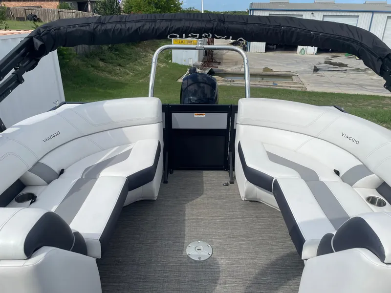 Slide: The Image of 2022 Misty Harbor Diamante Series boat with white and gray seating, outdoor setting. - 9