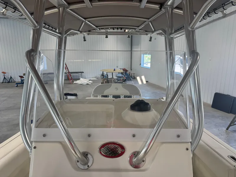 Slide: The Image of 2011 Edgewater 228CC boat interior with metal framework in a spacious garage. - 12