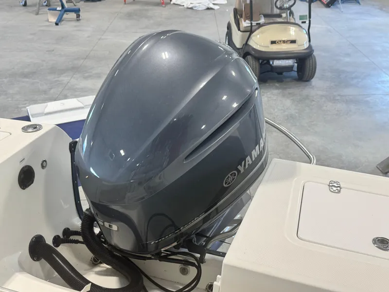 Slide: The Image of Yamaha outboard motor on 2011 Edgewater 228CC boat in a garage setting. - 15