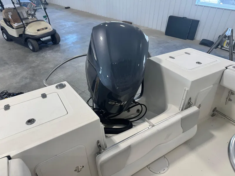 Slide: The Image of 2011 Edgewater 228CC boat with a 250 horsepower outboard motor in a garage. - 18