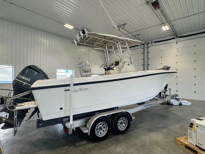 Slide: The Image of 2011 Edgewater 228CC boat with Yamaha engine in a garage setting. - 2