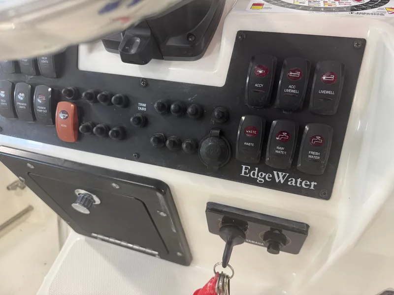 Slide: The Image of Control panel of a 2011 Edgewater 228CC boat with various switches and labels. - 25