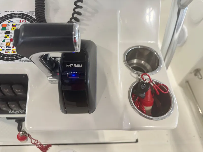 Slide: The Image of Edgewater 228CC 2011 boat console with Yamaha throttle and safety lanyard. - 26