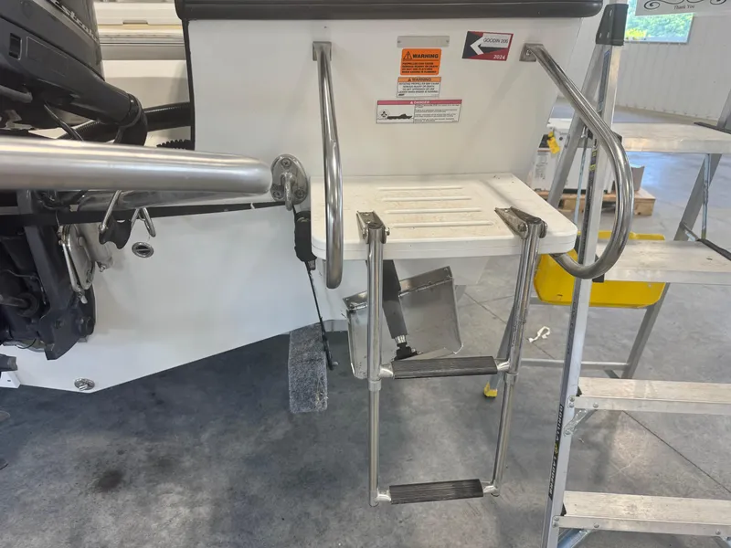 Slide: The Image of 2011 Edgewater 228CC boat ladder and platform in a garage setting. - 28