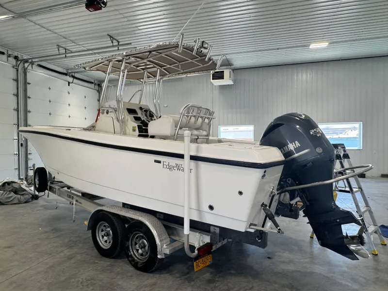 Slide: The Image of 2011 Edgewater 228CC boat with Yamaha engine on trailer in garage. - 3