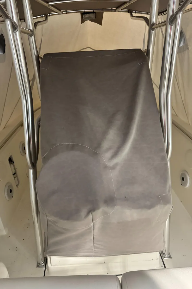 Slide: The Image of 2011 Edgewater 228CC boat interior with covered console and stainless steel frame. - 30