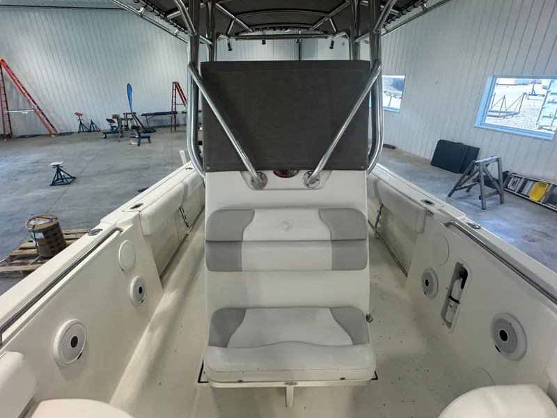 Slide: The Image of Interior of a 2011 Edgewater 228CC boat in a spacious garage setting. - 6