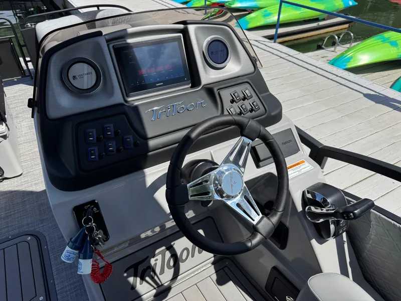 Slide: The Image of Steering console of 2026 JC SportToon 24 TT DSL boat at dockside. - 16