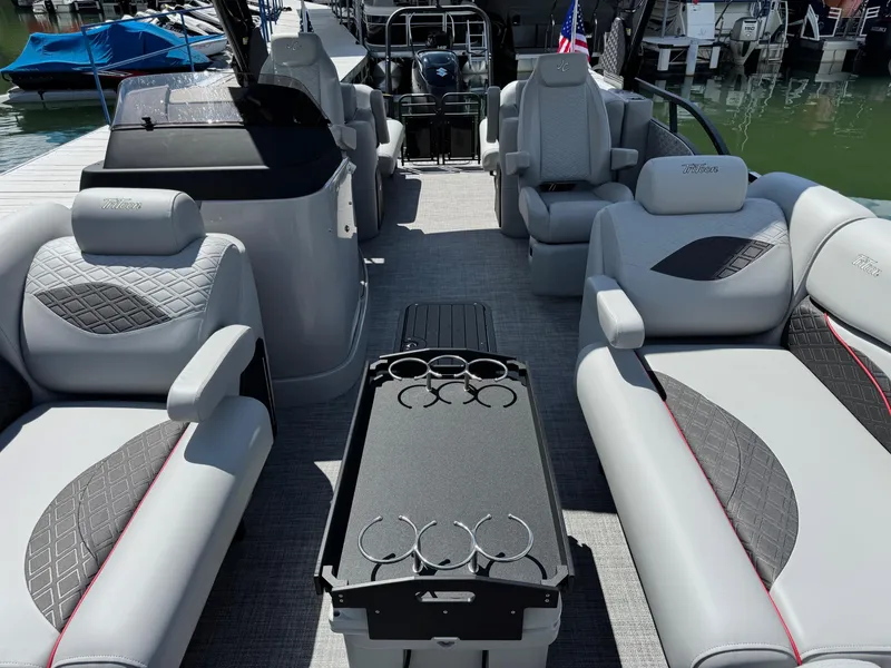 Slide: The Image of 2026 JC SportToon 24 TT DSL pontoon boat interior with luxurious seating and cup holders. - 5