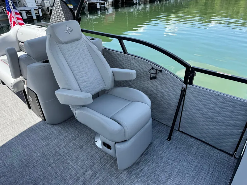 Slide: The Image of Luxurious seating on 2026 JC SportToon 24 TT DSL pontoon boat by the water. - 6