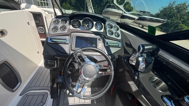 Slide: The Image of Cockpit of 2014 Monterey 328 Super Sport boat with modern controls and steering wheel. - 10