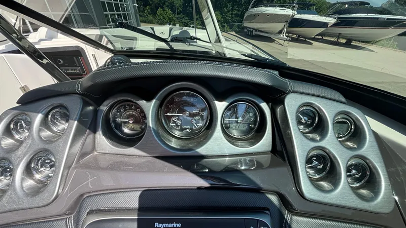 Slide: The Image of Dashboard of a 2014 Monterey 328 Super Sport boat with gauges and controls. - 11