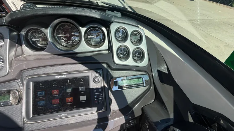 Slide: The Image of Dashboard of a 2014 Monterey 328 Super Sport boat with gauges and navigation system. - 12