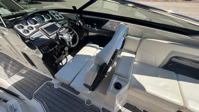 Slide: The Image of 2014 Monterey 328 Super Sport boat interior with sleek dashboard and white seating. - 16