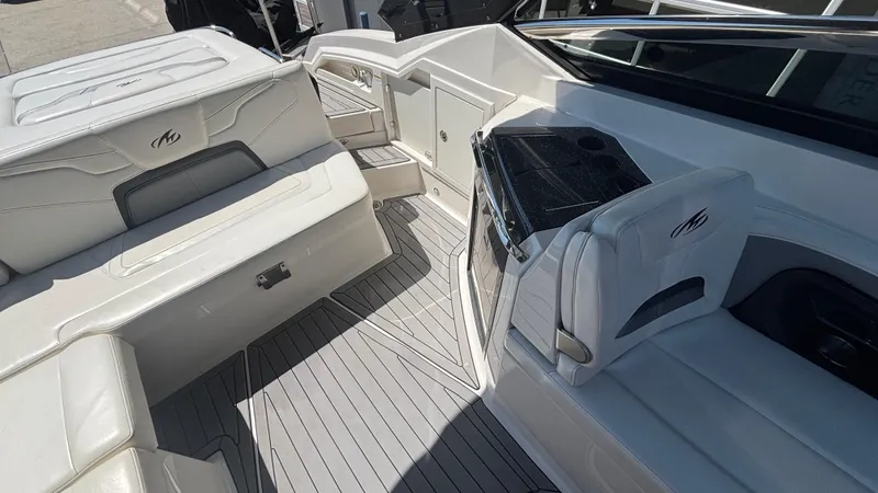 Slide: The Image of 2014 Monterey 328 Super Sport boat interior with white seating and sleek design. - 18