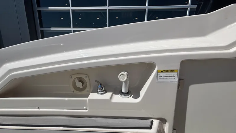Slide: The Image of 2014 Monterey 328 Super Sport boat detail with faucet and warning label. - 23