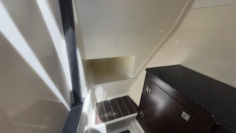 Slide: The Image of Interior of 2014 Monterey 328 Super Sport boat, featuring sleek cabinetry and modern design. - 29