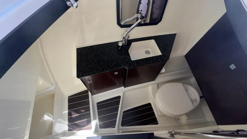 Slide: The Image of 2014 Monterey 328 Super Sport boat bathroom with sink, toilet, and dark countertop. - 30