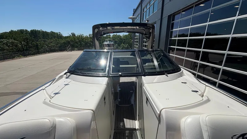 Slide: The Image of 2014 Monterey 328 Super Sport boat docked near a modern building. - 31